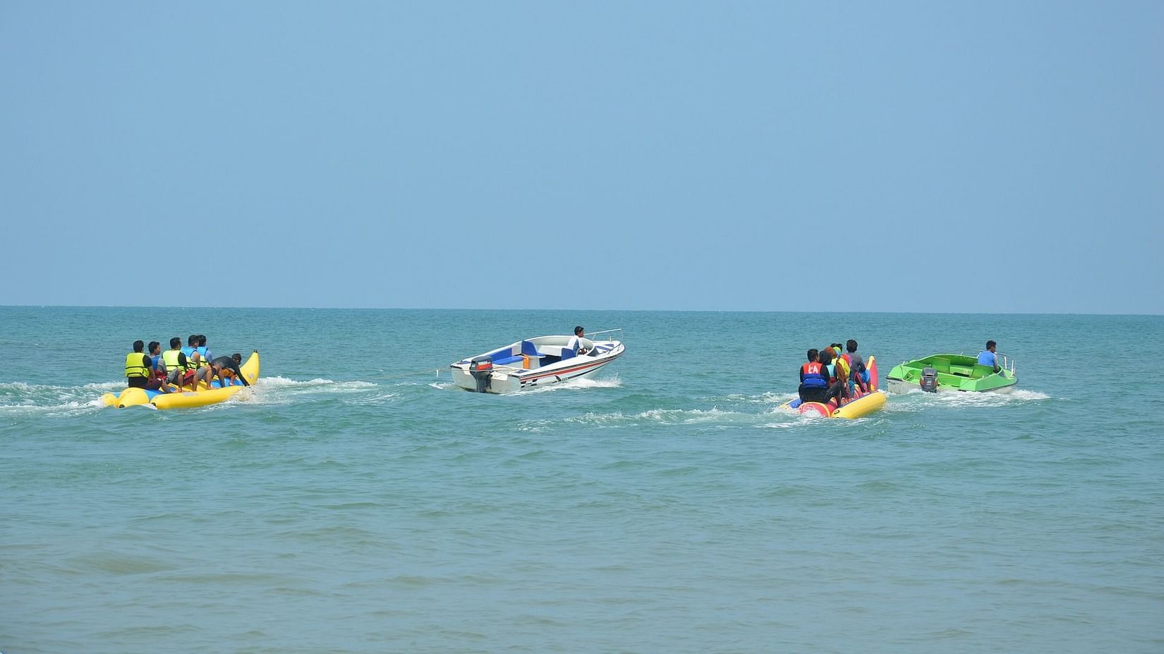 People enjoying a banana boat ride in the ocean