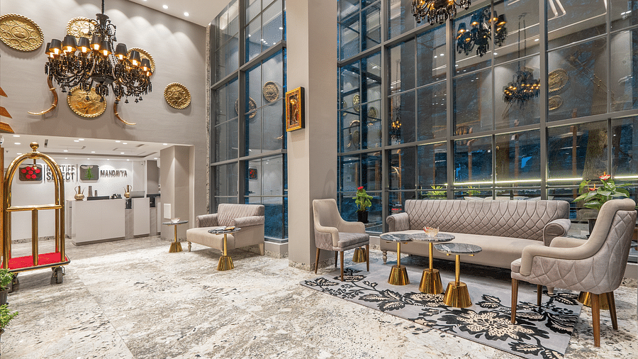 an image of lobby area with sofas and front desk