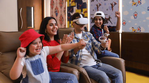 A family of four having fun while the father is on a VR headset - Heritage Village Resorts & Spa, Manesar