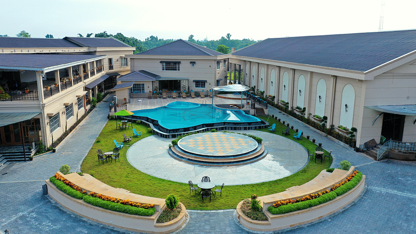 Aerial view of Voyage the Solitaire Bliss with a garden area and buildings on the side.