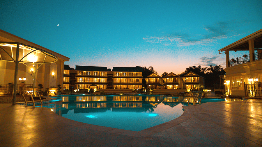 Night view of the facade of Voyage The Solitaire Bliss with a swimming pool in front.