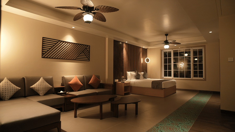 Image of suite with bed, seating area and two ceiling fans at Voyage The Solitaire Bliss.