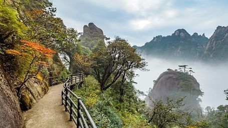 An image of a pathway by the side of mountains