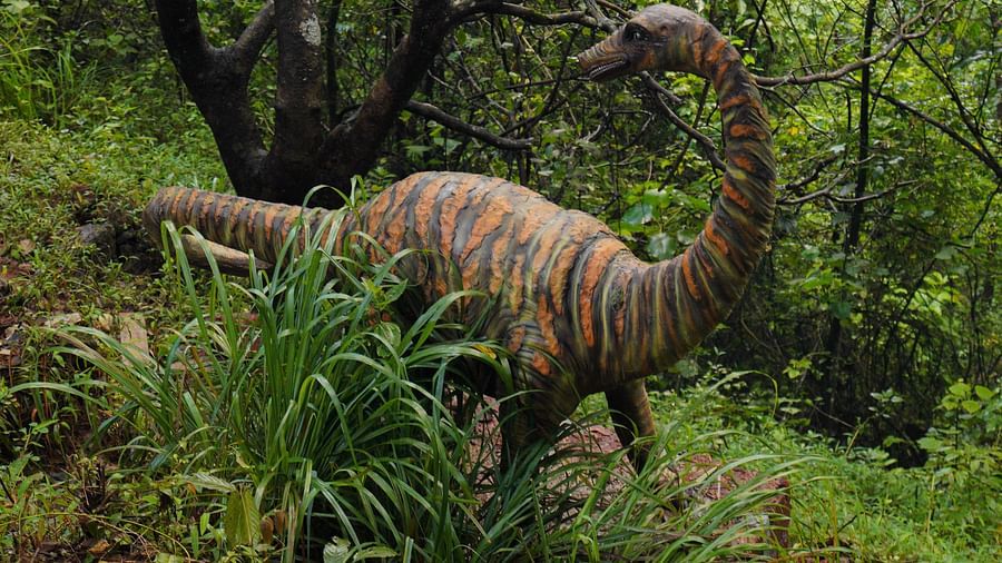 a statue of a dinosaur inside Holistic Stay Eco Resort, Kannur
