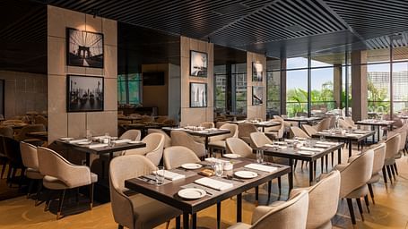 A view of dining area at Citron Bar with comfortable seating at Essentia Premiere, Pune.