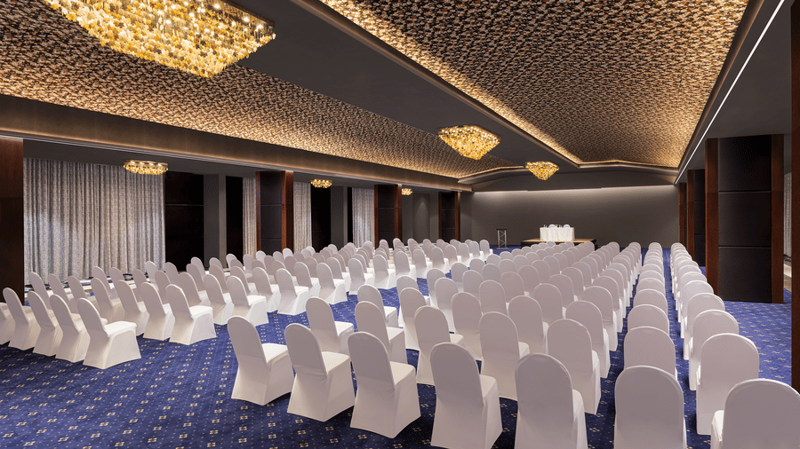 Seating arrangement in Grand Ballroom, our marriage venue in Indore at Essentia Luxury Hotel featuring rows of chairs under warmly-lit ceiling