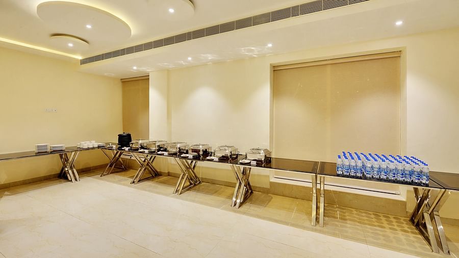 Modern event space with sleek buffet tables and circular ceiling lights.