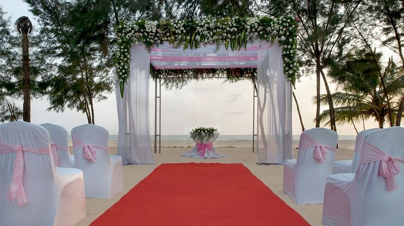 A glimpse of Sea Mist with a podium for exchanging vows and seating arrangement in front of it - Kenilworth Resort and Spa