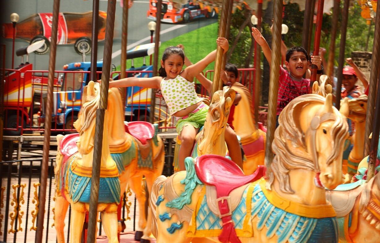 kids enjoying in the horse ride at MGM Dizzee World