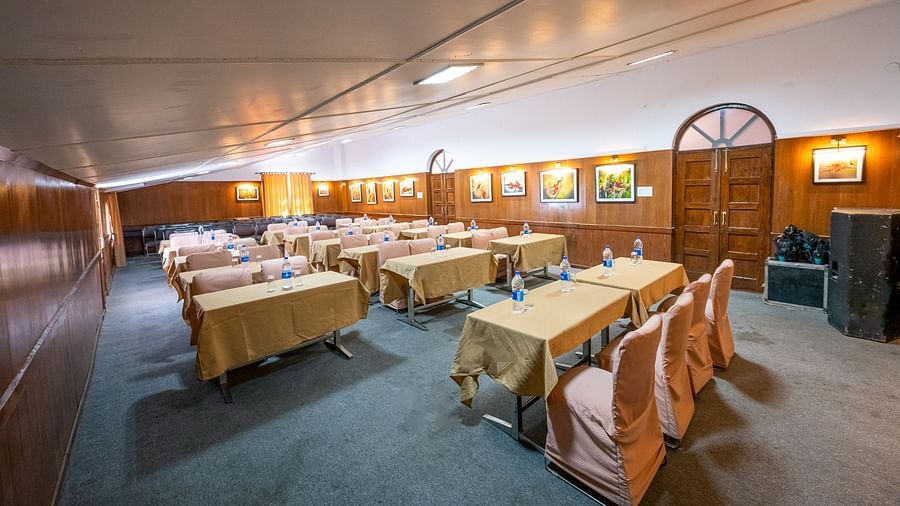 Row-wise seating arrangements in the conference hall with stylish interior design at The Pavilion, Nainital