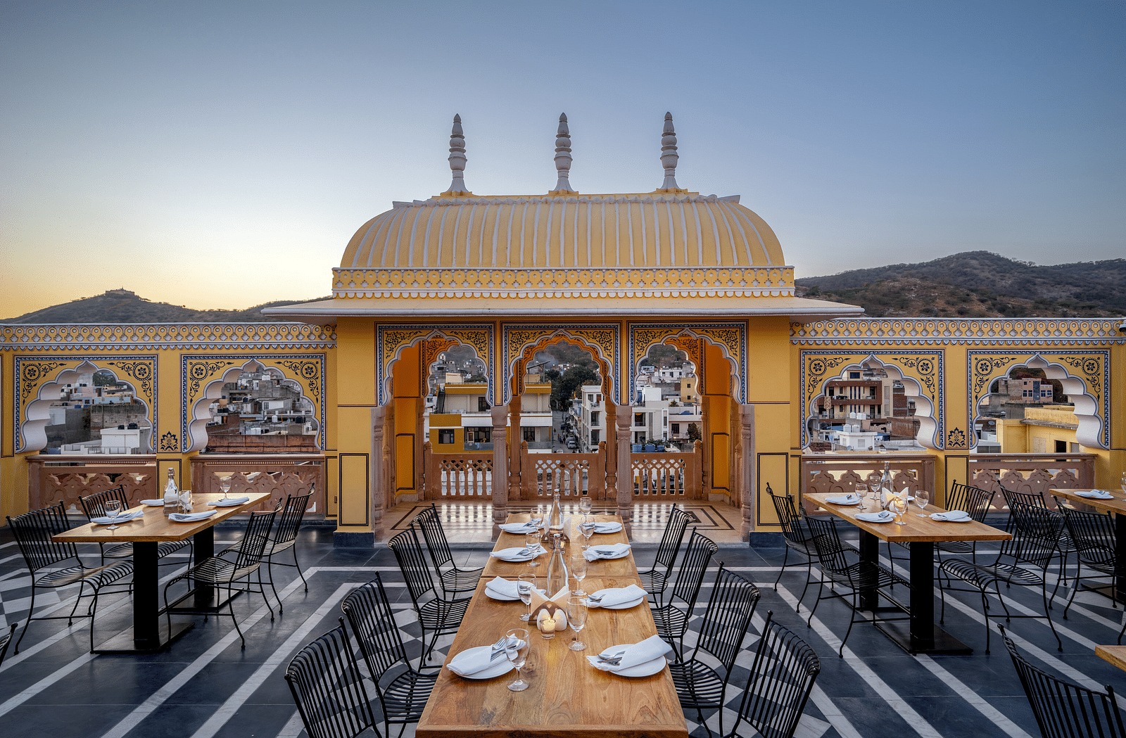 a bright image of the rooftop dining area with tables well arranged with plates and cutlery13-March-2025