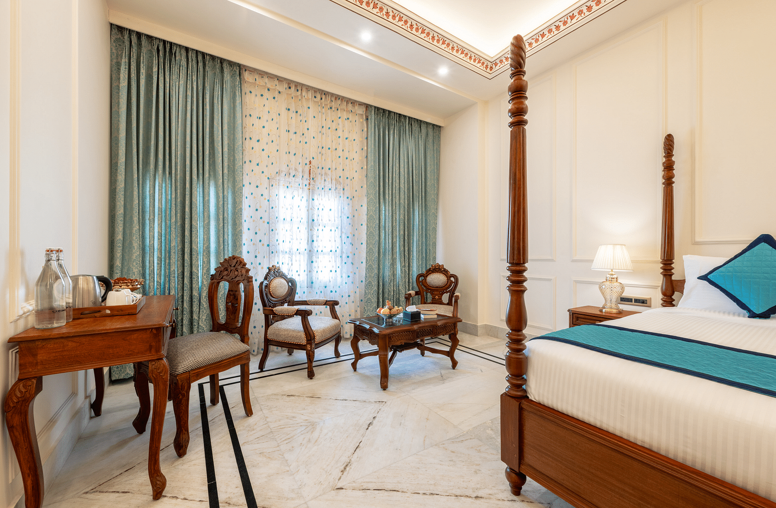 a bedroom featuring the common seating area along with a work desk and chair - Brij Castle, Jaipur