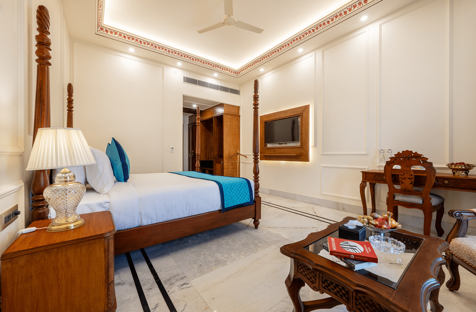 corner view image of the bedroom featuring a double bed along with a coffee table - Brij Castle, Jaipur