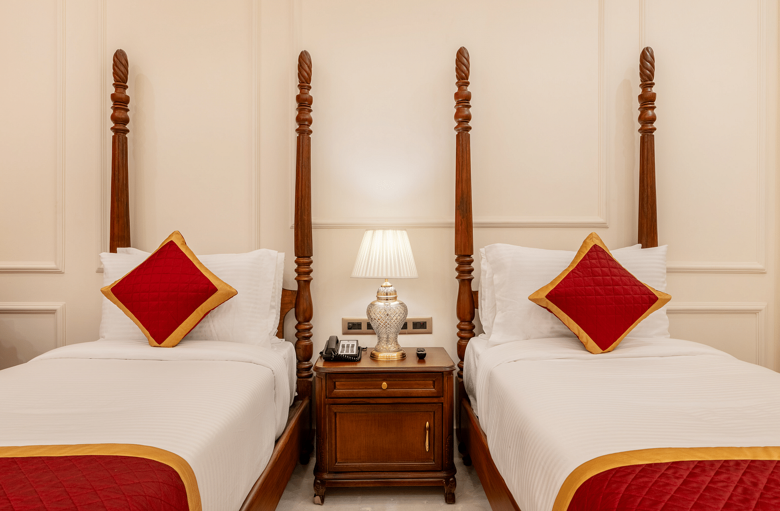 front view image of the two cosy single beds with a common bed side table between them with a lamp - Brij Castle, Jaipur
