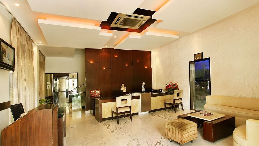 A modern hotel lobby with contemporary furniture, warm lighting, and a welcoming reception area at The President Hotel, Jayanagar.