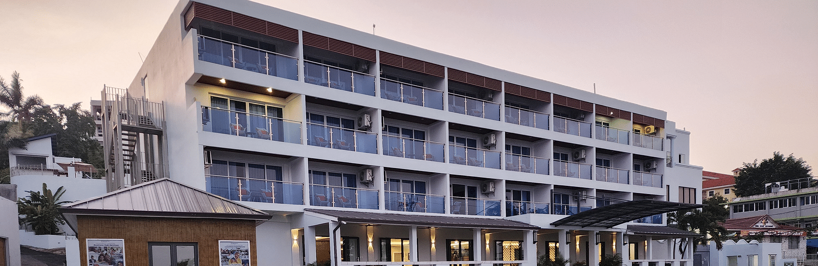 A hotel exterior with an electric car charging station in the parking lot - Hotel 39, Jamaica