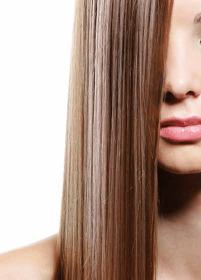 A close-up pf straight, shiny hair of a woman showcasing a sleek and polished look