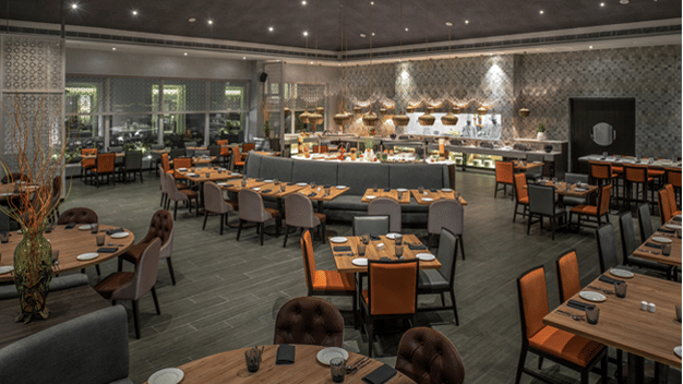 Restaurant at The Residency Towers Rameswaram featuring dining tables and chairs