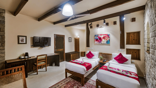 Bright resort bedroom with two twin beds and plenty of natural light.