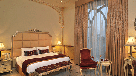 Image of a room with a bed and a chair on the side at Rajasthali Resort & Spa Jaipur.