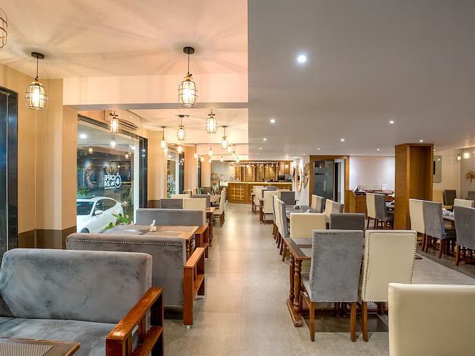 Image of M Cafe with sofa and tables at Vagator Downtown, Goa
