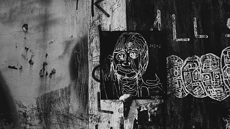 An overview of a black and white image with a Graffiti on a wall on Sukhumvit road.