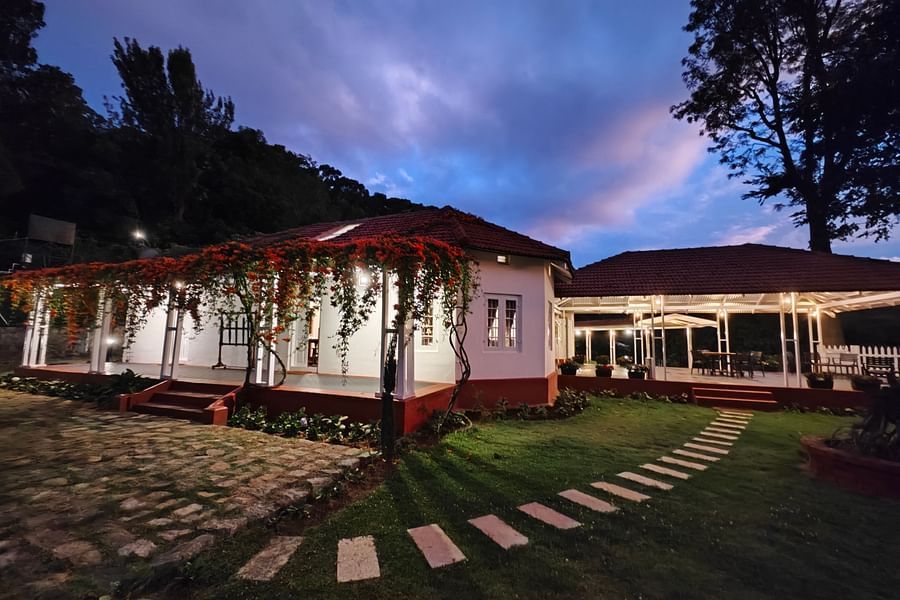 Facade image of Ibex Stays & Trails, Coonoor (Leewood) during twilight with the lights on.