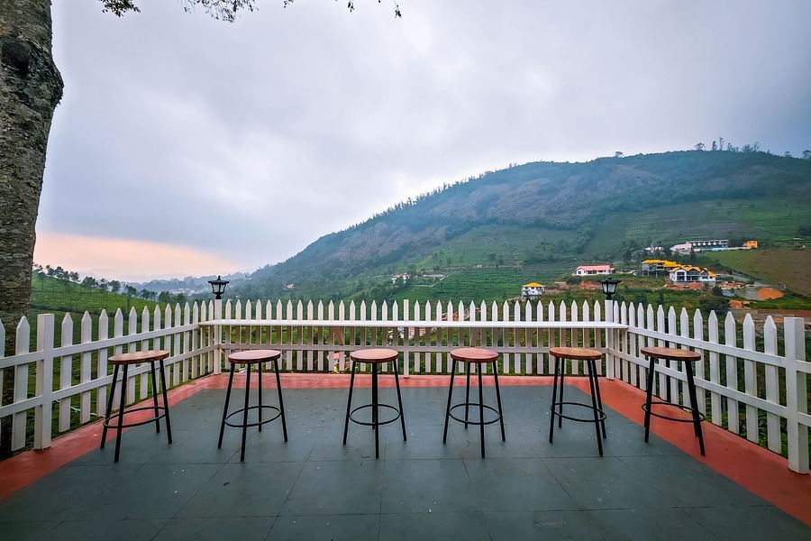 Stools kept on a viewing deck with a hill in the background - Ibex Stays & Trails, Coonoor (Leewood).