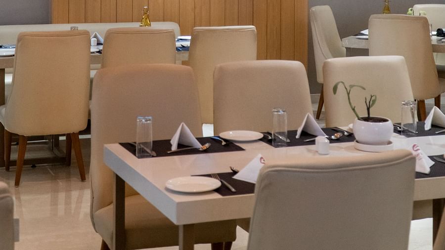 A view into a restaurant dining area with tables and chairs.
