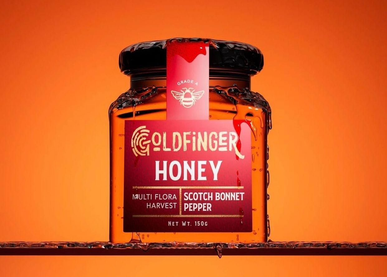 A close up shot of a red coloured bottle filled with honey and a sticker representing the name of the gift shop - Hotel 39, Jamaica