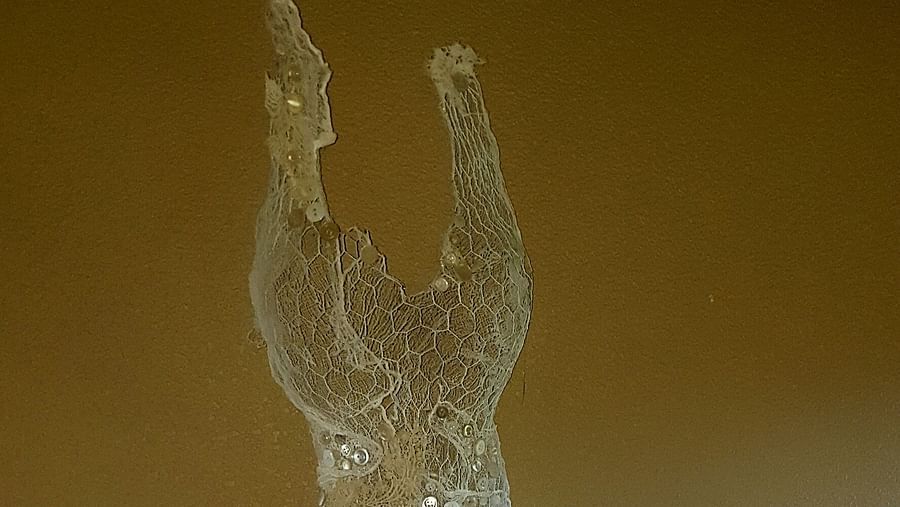 A delicate lace dress displayed as an artistic centrepiece - Brewery Gulch Inn & Spa