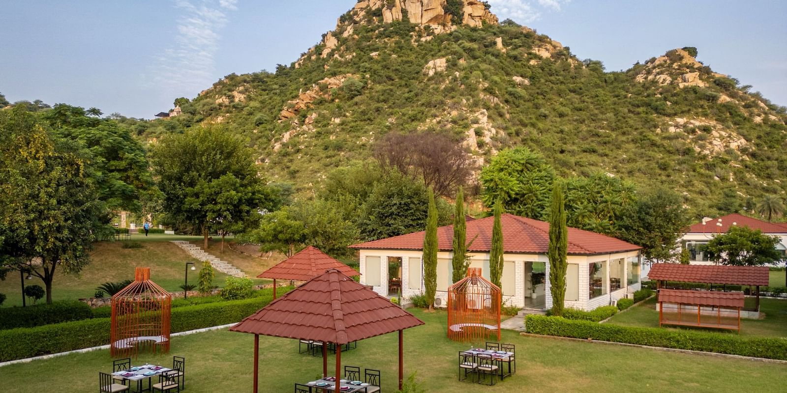 Top view of an open-air dining space at Valley by Grassfield, set against a stunning mountain backdrop.