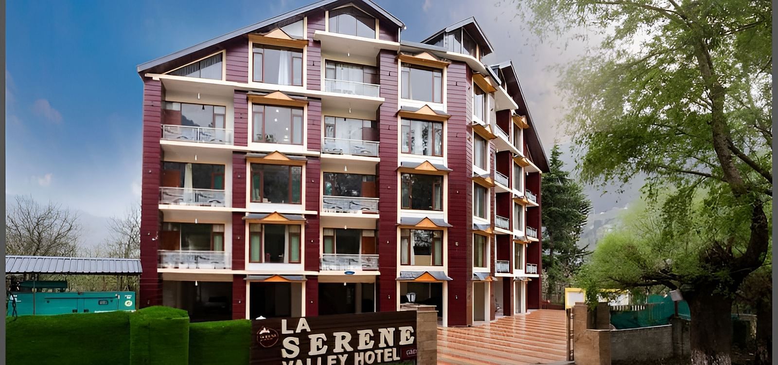 Image of the facade of the hotel with clear sky in the background | DLS La Serene Manali