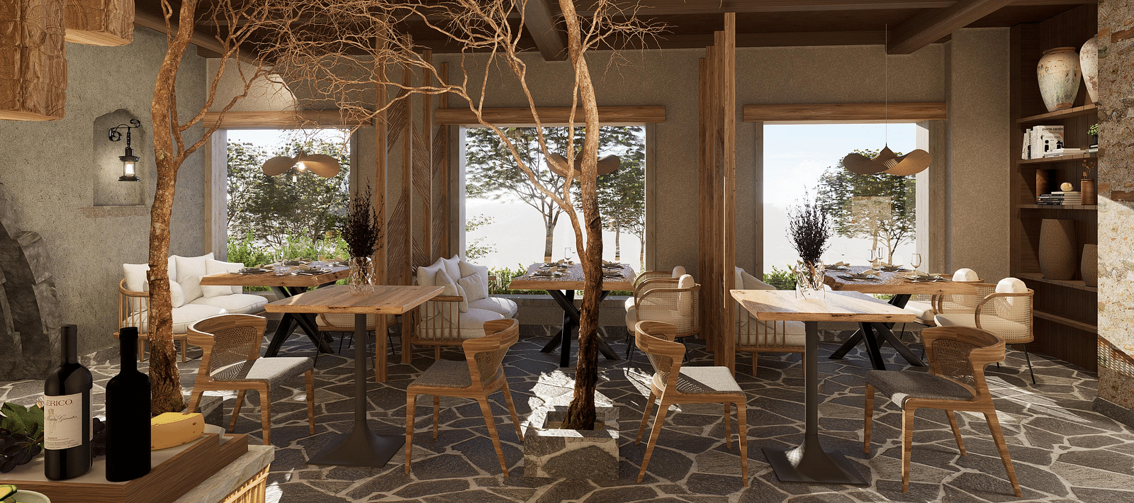 Side view of the restaurant at The Evren, Vagator, with arranged tables, chairs, and windows overlooking greenery.
