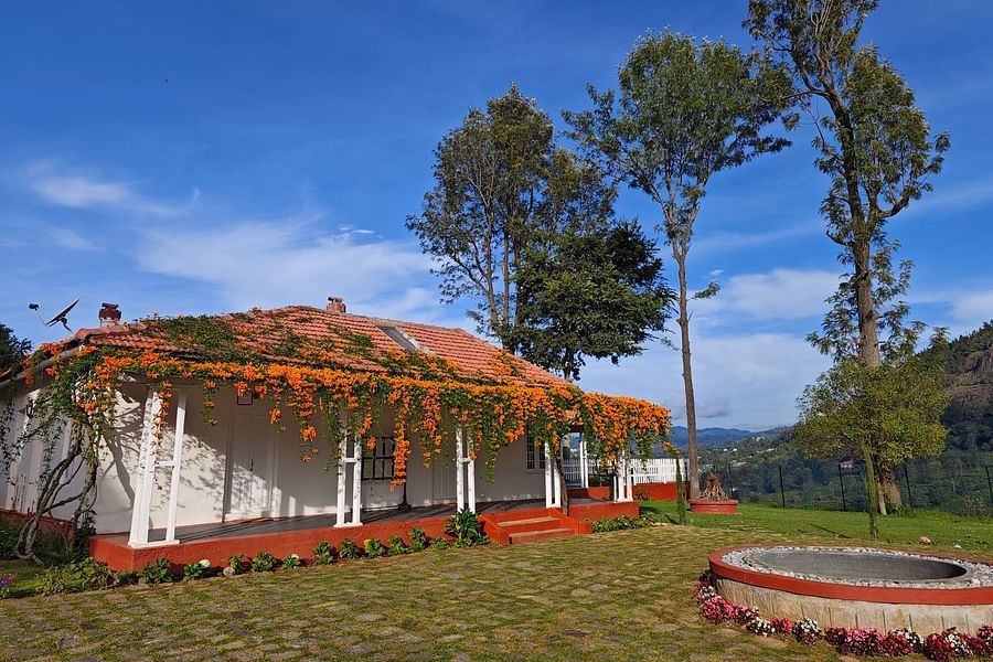 Facade image of a room in the daylight with a well in front of it - Ibex Stays & Trails, Coonoor (Leewood).
