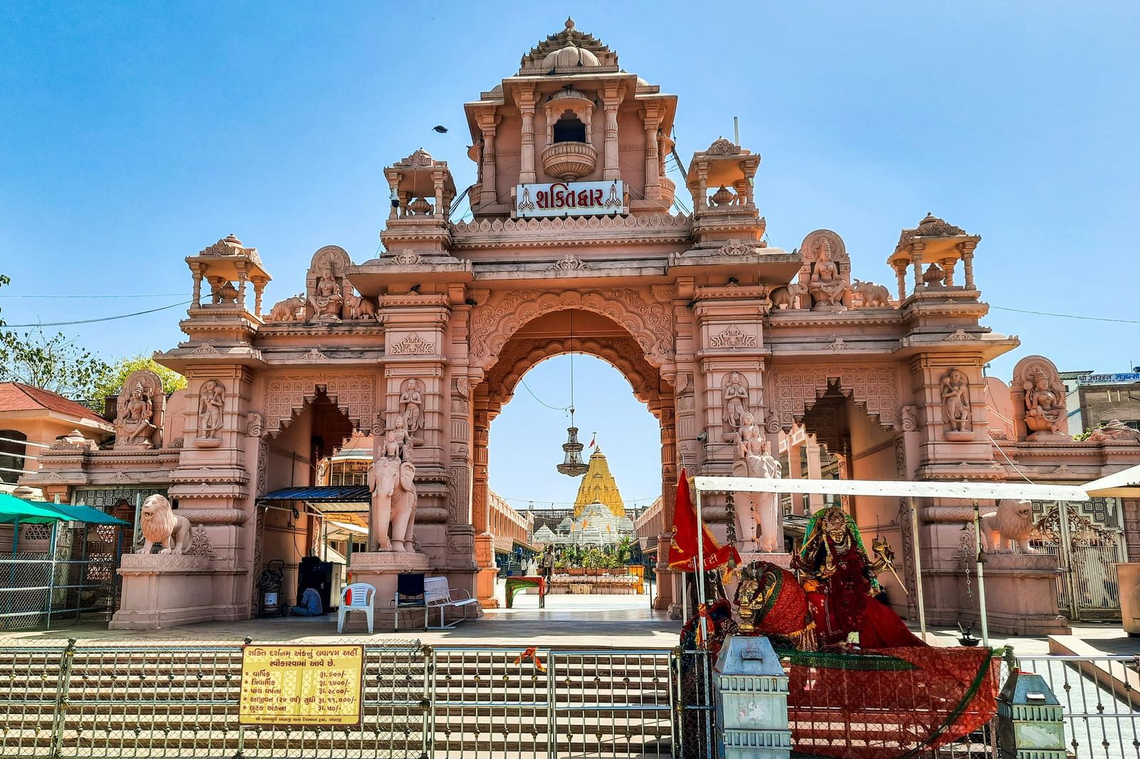 Entrance gate to a temple of complex with a clear blue sky in the background.