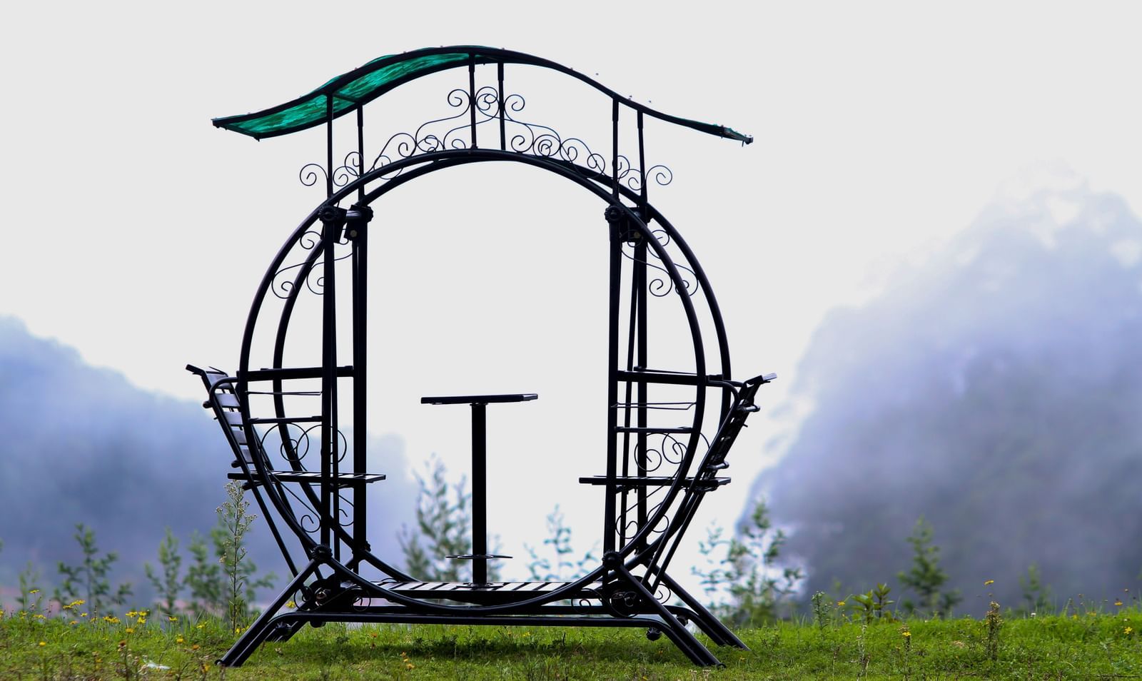 A close up of a swing in the lawn area of Accord Highland Ooty on a cloudy day