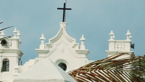 The Holy Cross situated at the building top of a Church
