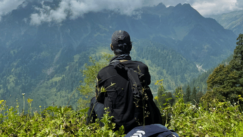 man sitting on mountain 