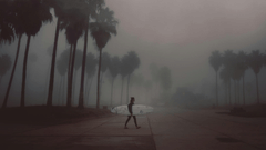 man walking with surfboard