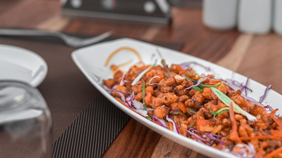 Crispy corn served in a plate on the table at The Bridge restaurant at Clarks Inn Suites Jaipur