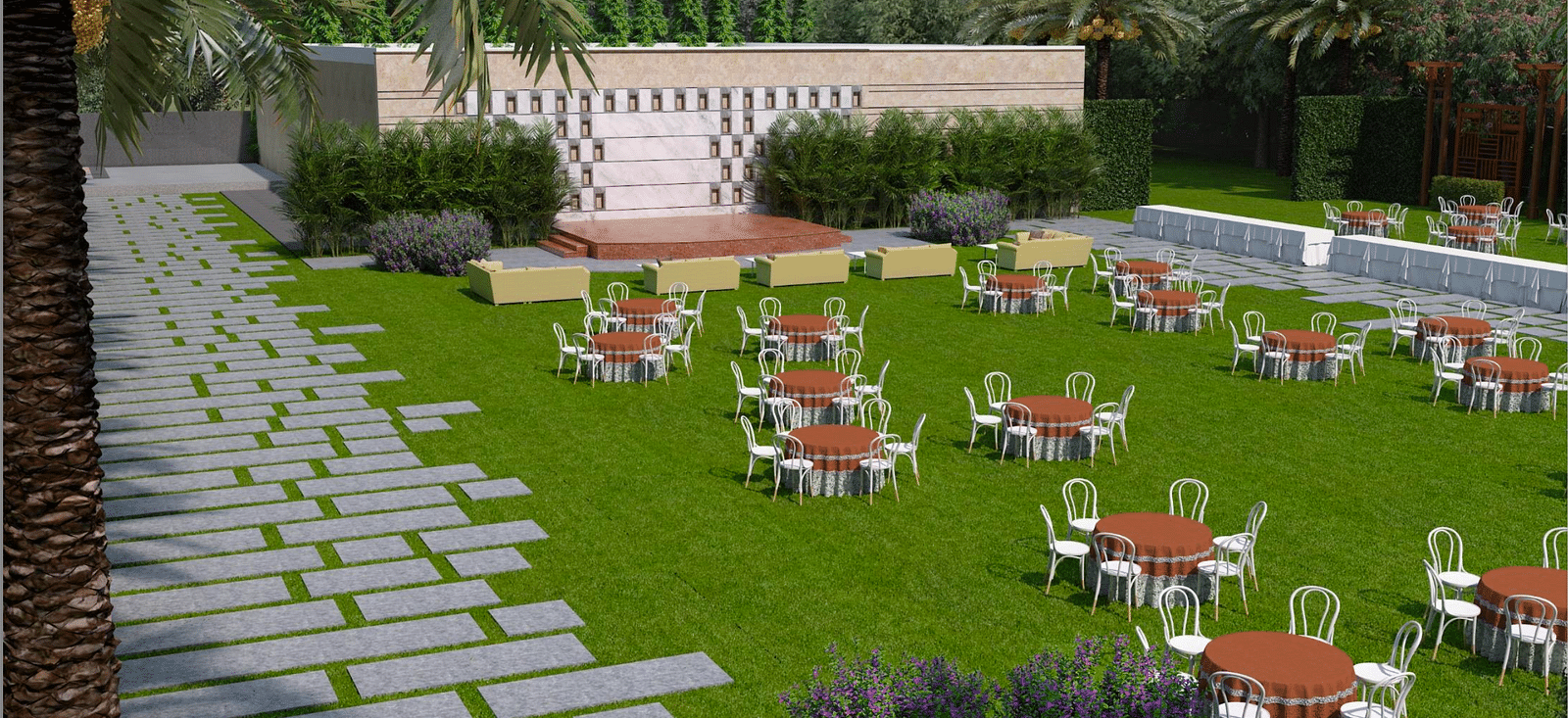 A lawn area with chairs and tables, a stone pathway and palm trees on either side
