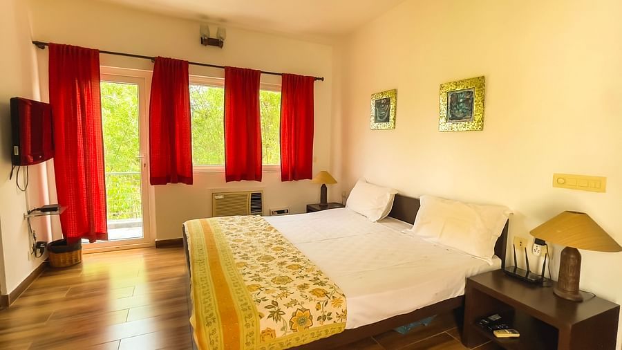 King bed with lamp on side table at el benito goa