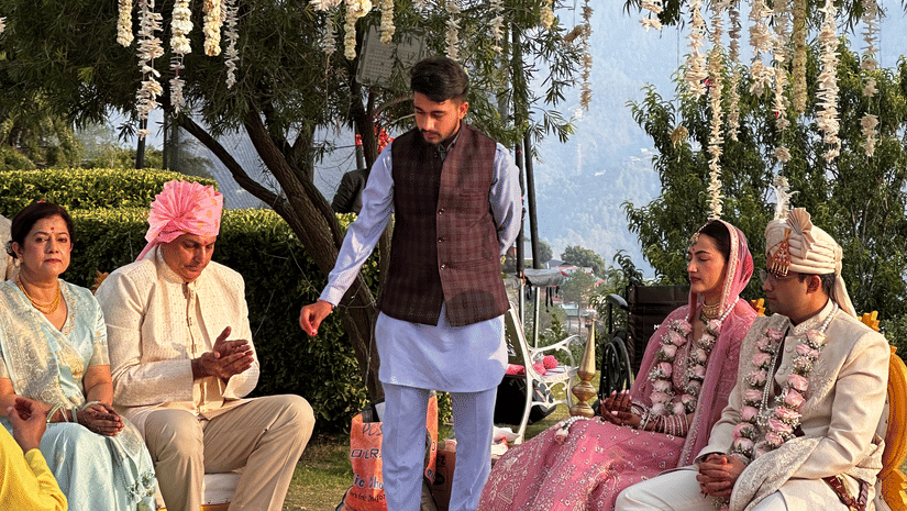 Outdoor wedding ceremony setup with guests seated among tall trees at The Manor Sports & Wellness Hotel.