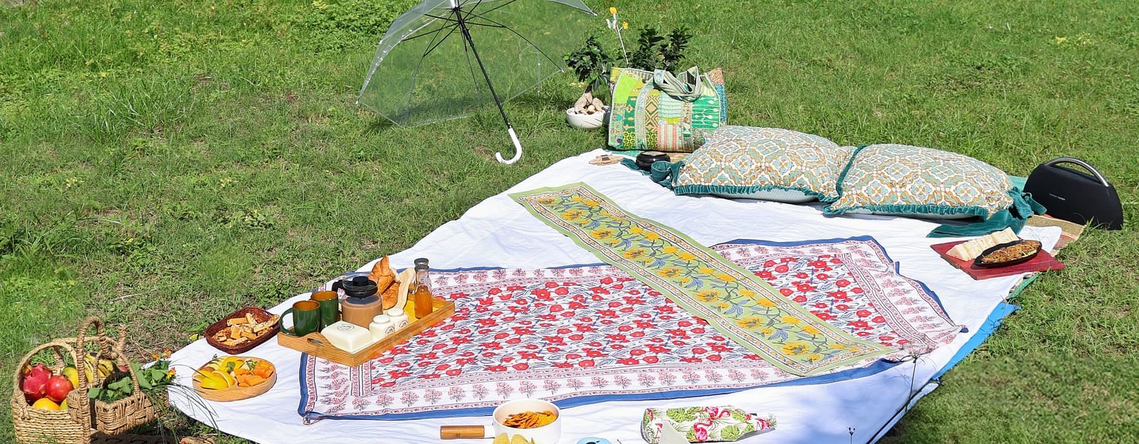 A picnic setting placed on a grass field at The Sylvan Retreat, Dehradun on a sunny day,