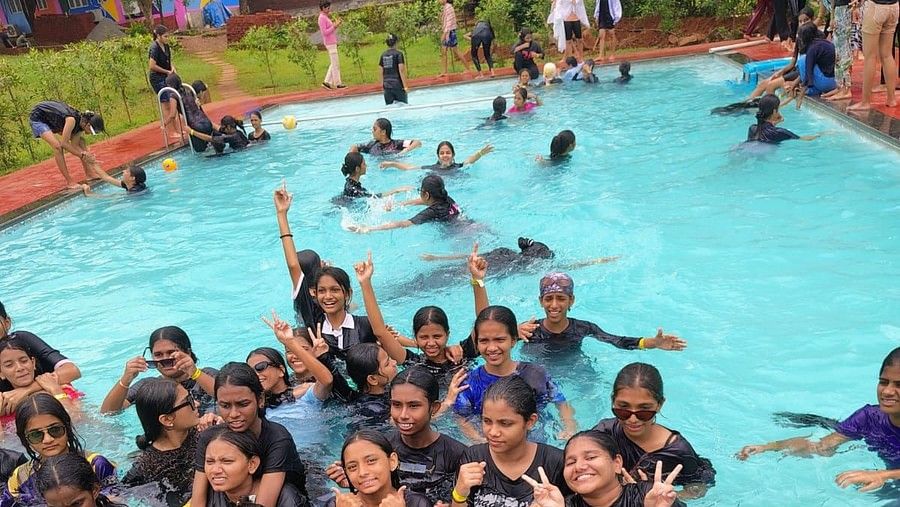 A large group of girls on a swimming pool while most of them facing the same direction in a joyous manner