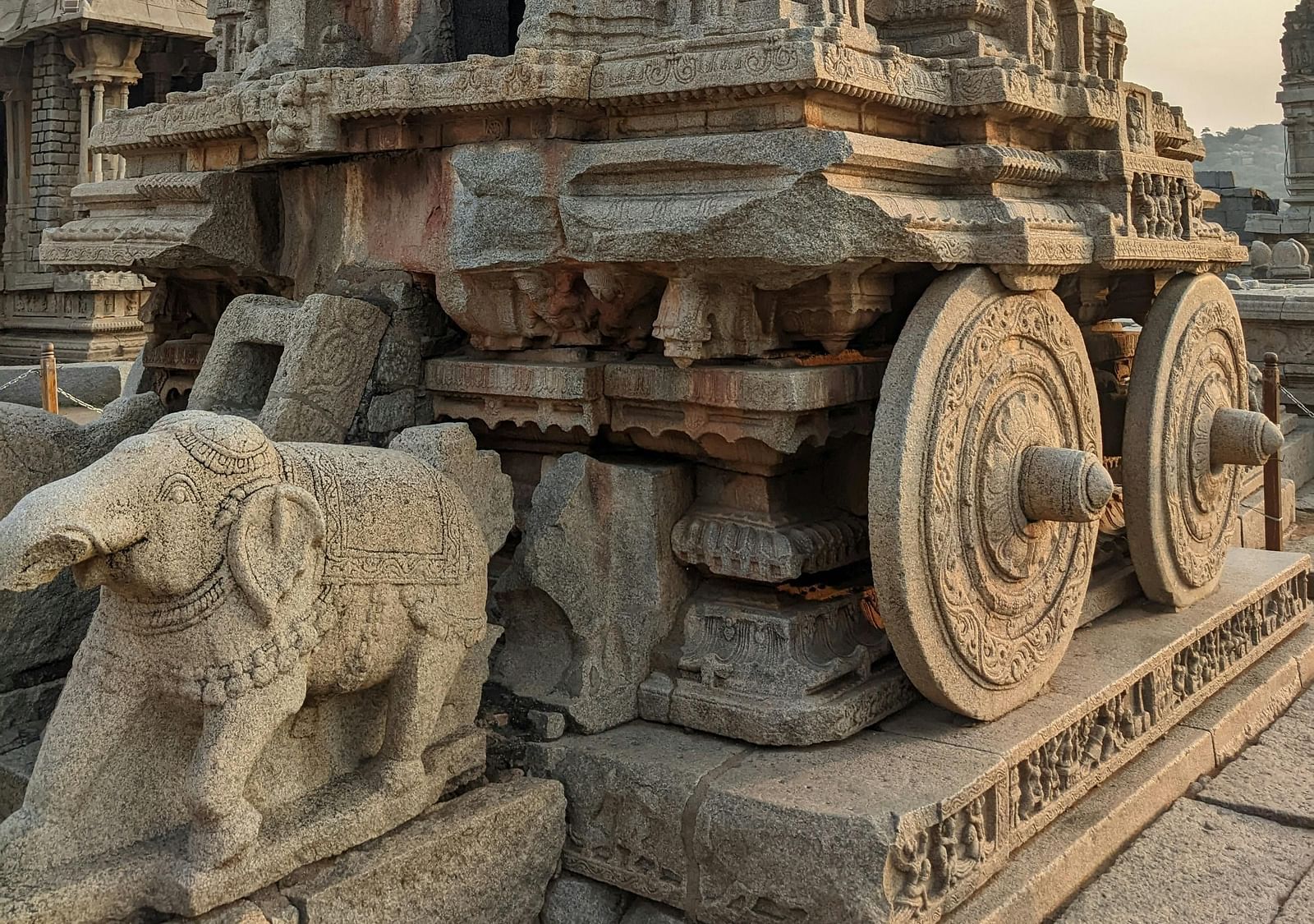 Exterior photograph of a stone chariot with intricate carvings.