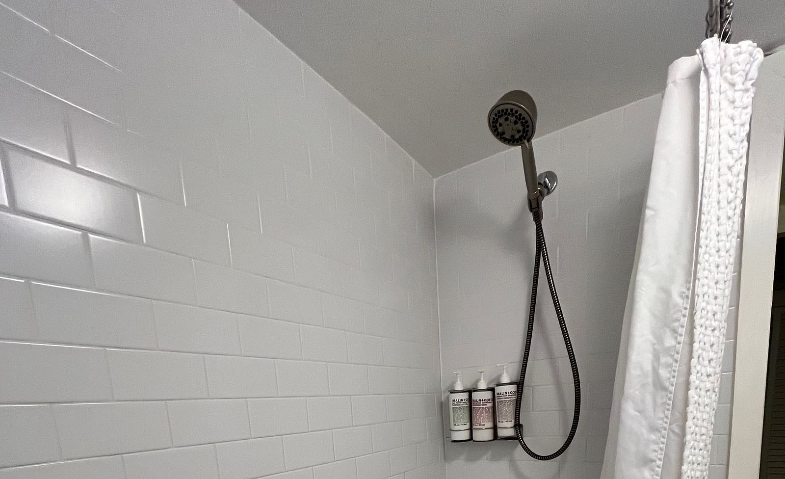 a bathroom at casa morada with a curtained bathtub and a shower.