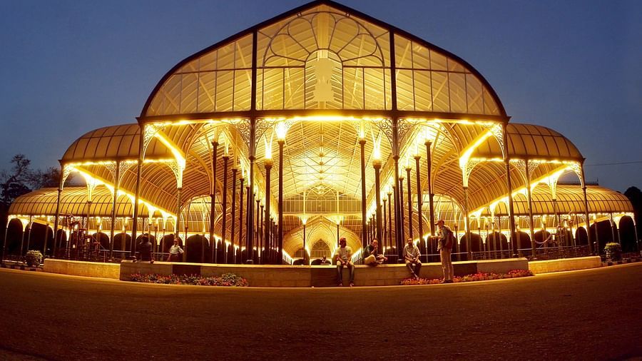 Glasshouse at Lalbagh Botanical Garden during a flower show, filled with colourful floral arrangements.