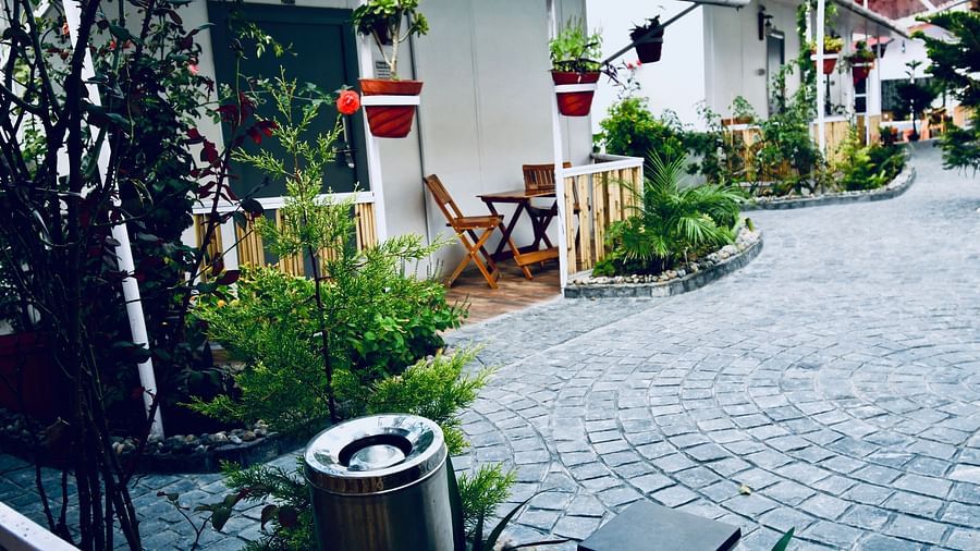 image of the exterior at the Tattva, joshimath with a lot of plants outside the villas